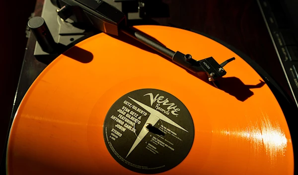 A vinyl record by The Verve plays on a turntable, May 27, 2021, in Falmouth, Maine (AP).