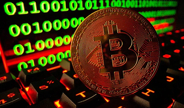 Bitcoin cryptocurrency representation is pictured on a keyboard in front of binary code in this illustration taken September 24, 2021 (Reuters).