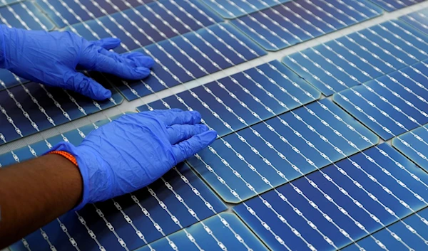 A worker makes arrangements of solar cells at Premier Energies Solar on the outskirts of Hyderabad, India, Jan. 25, 2023. (AP)