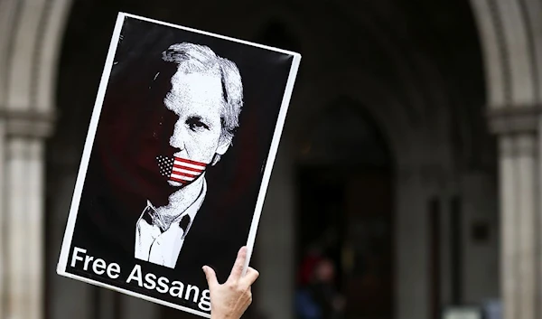 A supporter of Wikileaks founder Julian Assange protests outside the Royal Courts of Justice in London, Britain, October 27, 2021. (Reuters)