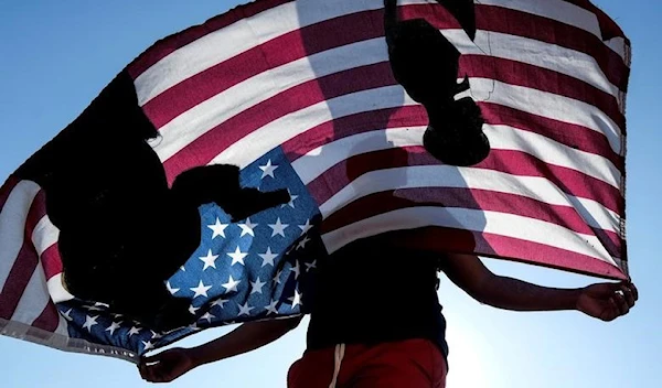 A demonstrator holds a flag during a protest against racial injustice, in Compton, California, June 21, 2020. (Reuters)