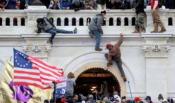 A mob of supporters of U.S. President Donald Trump fight with members of law enforcement at a door they broke open as they storm the U.S. Capitol Building in Washington, U.S., January 6, 2021. (Reuters)