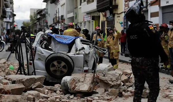 A car crushed by debris after an earthquake shook Cuenca, Ecuador, on Saturday. (AP)