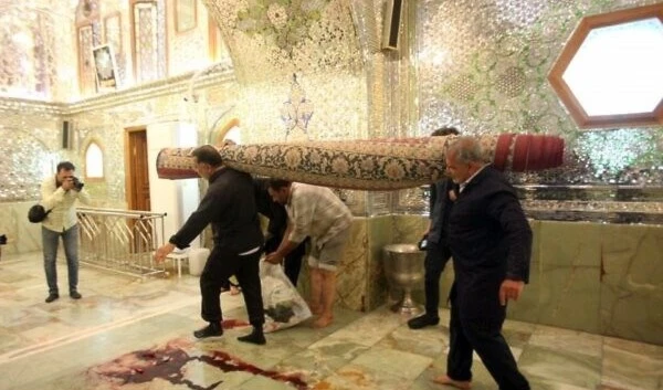 Workers clean up following terrorist attack at the Shah Cheragh mausoleum in the Iranian city of Shiraz on October 26, 2022. (AFP)