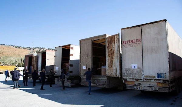 Trucks carrying humanitarian aid are seen at the Bab al Hawa border crossing with Syria on  February 9, 2023. (Reuters)