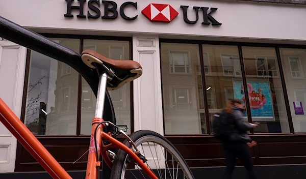 A person walks past an HSBC branch, in London, Monday, March 13, 2023 (AP).