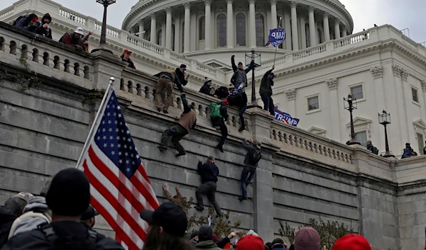 Supporters of U.S. President Donald Trump climb a wall during a protest against the certification of the 2020 presidential election results by the Congress, at the Capitol in Washington, U.S., January 6, 2021. Picture taken January 6, 2021. (Reuters)