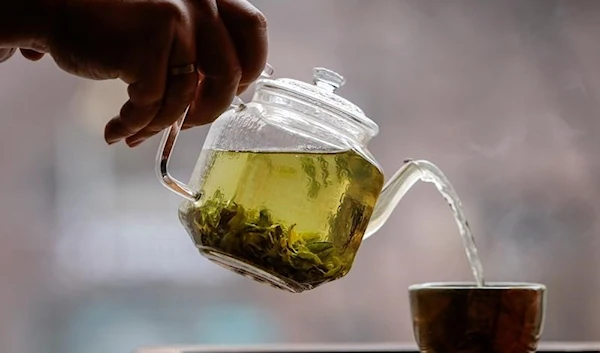 The owner of a tea house pours a cup of tea in this picture illustration taken April 25, 2020. (Reuters)