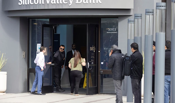 Igor Fayermark (L) from the FDIC enters Silicon Valley Bank's headquarters in Santa Clara, Calif., on Monday, March 13, 2023.