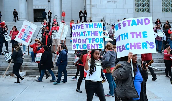 Striking teachers and supporters rally outside City Hall as negotiations resume on Friday, January 18th, 2019, in Los Angeles, California (AFP)