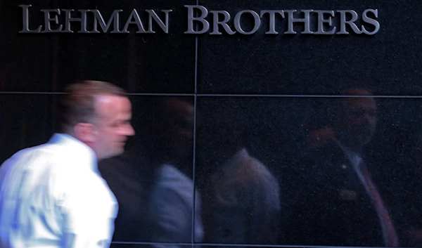 Lehman Brothers employee leaves the building on Wednesday, June 10, 2008 in New York (AP).