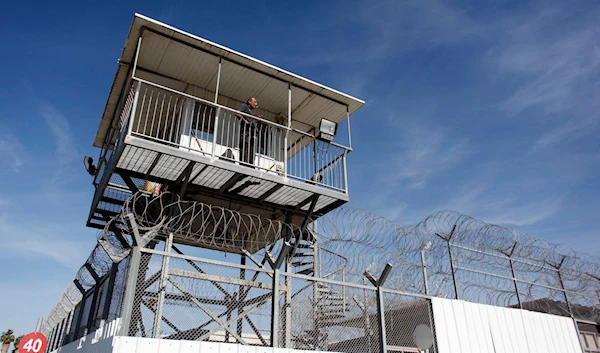 An Israeli occupation prison guard keeps watch from a tower at 'Ayalon' prison near 'Tel Aviv', occupied Palestine, February 13, 2013 (Reuters)