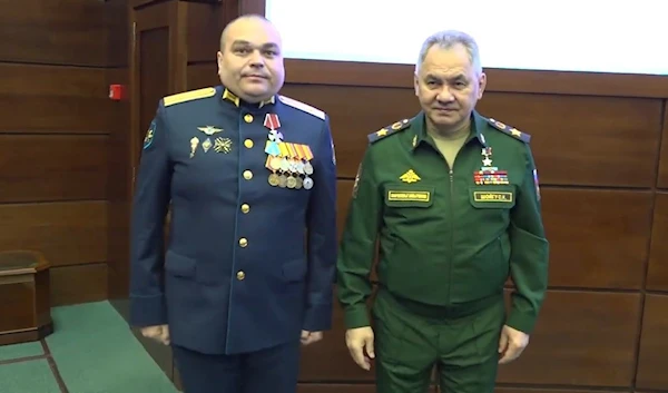 A screen grab from a video published by the Russian Ministry of defense showing Denfense Minister Shoigu and the decorated Su-27 Pilot, March 22, 2023 (Russian MoD)