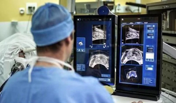 health worker examining radioactive scans of prostate cancer (AFP)