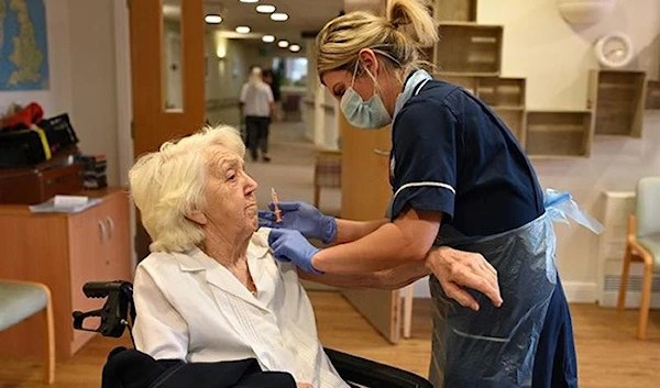 Practice nurse Victoria Parkinson gives a COVID-19 jab to a care home resident in Wigan (AFP)