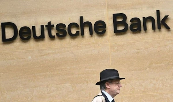 A worker walks past Deutsche Bank offices in London, Britain, March 16, 2023. (REUTERS)