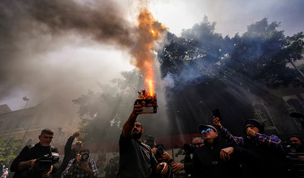 A protester launches fireworks at the Lebanese Central Bank building as frustrated depositors rally against Governor Riad Salameh and the deepening financial crisis in Beirut, Lebanon, March 24, 2023 (AP)