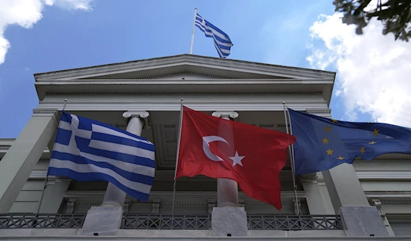 Greek, Turkish and European Union flags on the foreign ministry house before a meeting of a Greek Foreign minister and his Turkish counterpart in 2021. (AP)