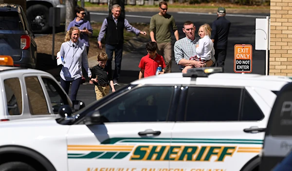 Families leave a reunification site in Nashville, Tennessee, on March 27, 2023, after several children were killed in a shooting at Covenant School in Nashville (AP)