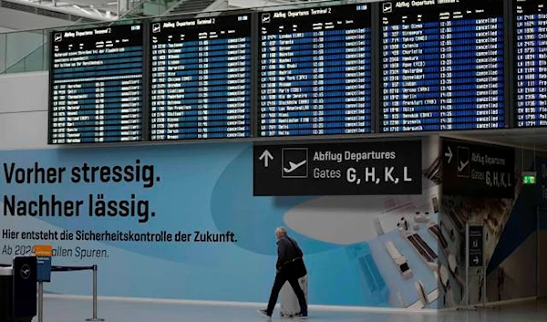 A man passes the deserted departure terminal during a strike in Bavaria at the airport in Munich, Germany, Sunday, March 26, 2023. (AP)