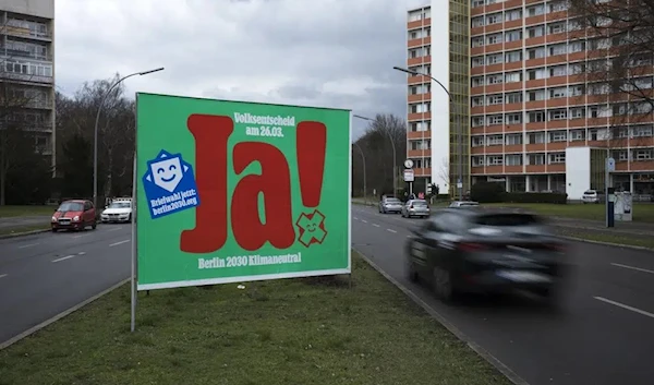 A poster with a huge "Yes", advertising a climate referendum stands out along a street in Berlin, Friday, March 24, 2023 (AP)