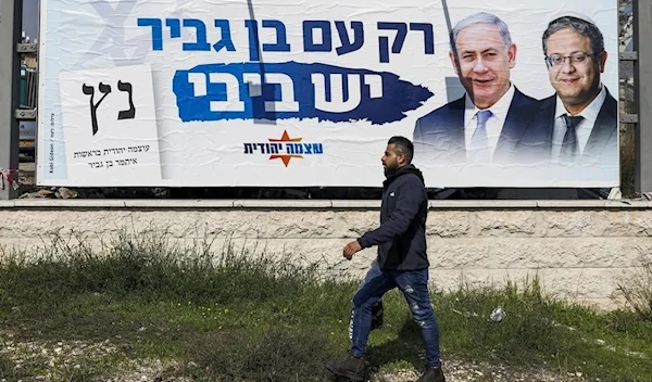 An electoral campaign billboard showing the faces of former Israeli prime minister Benjamin Netanyahu and far-right politician Itamar Ben-Gvir in Jerusalem on February 17, 2020, with a caption in Hebrew reading 'only with Ben-Gvir is there Bibi.' (AFP)