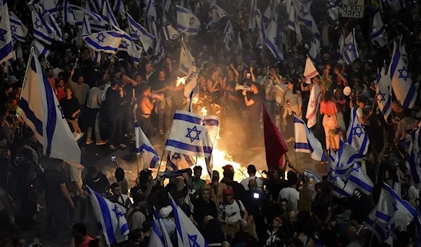 Israelis opposed to Prime Minister Benjamin Netanyahu's judicial overhaul plan set up bonfires and block a highway during a protest moments after the Israeli leader fired his defense minister, in Tel Aviv, Israel, Sunday, March 26, 2023. (AP)