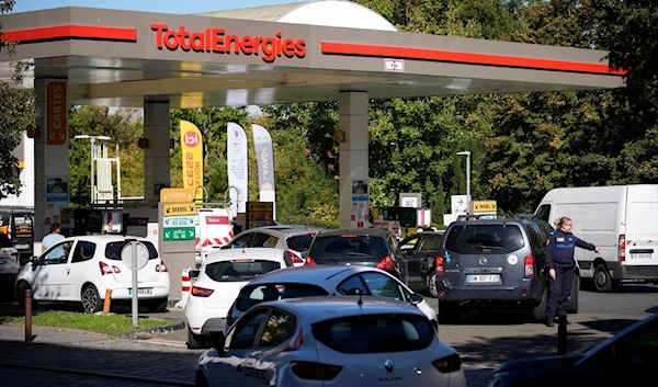 Cars lining up for gasoline in Paris on Tuesday. Strikes at refineries have left many French service stations without fuel. (AP)