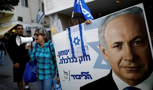 Supporters of Israeli Prime Minister Benjamin Netanyahu. The placards in Hebrew read, “Strong in security, strong in Economy “. Photo credit: REUTERS