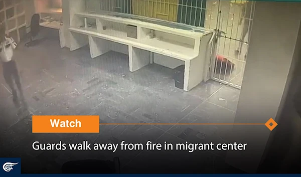 Guards walk away from fire in migrant center