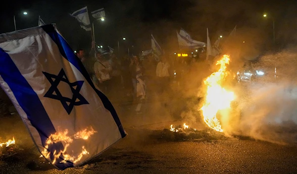 Anti-government protestors burn tires near 'Beit Yanai', occupied Palestine, March 27, 2023 (AP)