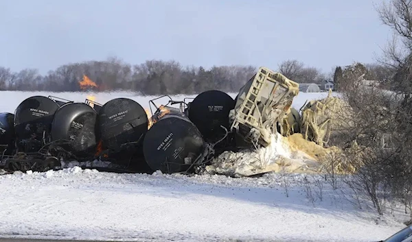 Smoke and fire appear after a BNSF train derailed in Raymond, Minn., Thursday, March 30, 2023. ((David Joles /Star Tribune via AP)