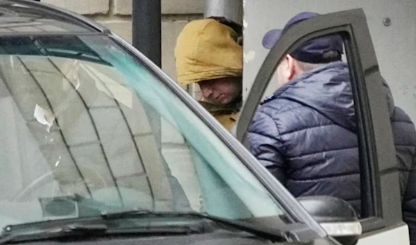 Evan Gershkovich is escorted by officers from the Moscow court to an awaiting vehicle. (AP)