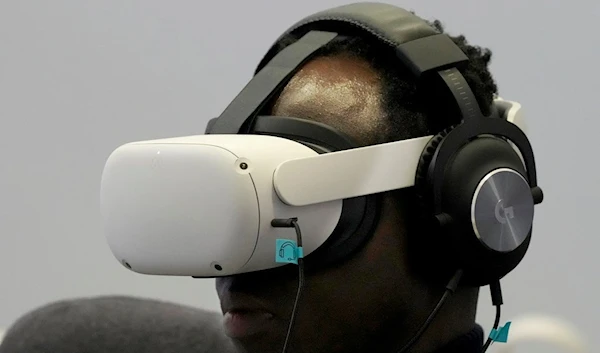 George Azaletey plays the virtual reality game Among Us while visiting the Meta booth at the Game Developers Conference 2023 in San Francisco, Wednesday, March 22, 2023 (AP Photo/Jeff Chiu)