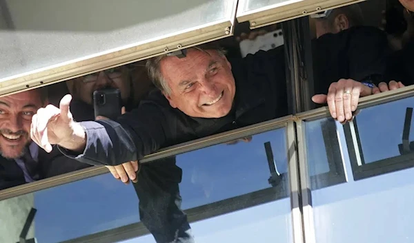 Brazil's former President Jair Bolsonaro waves to supporters at the Liberal Party's headquarters in Brasilia, Brazil, Thursday, March 30, 2023. (AP)