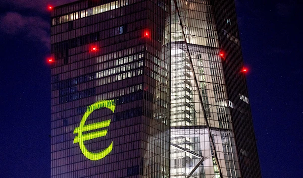 A light installation is projected onto the building of the European Central Bank during a rehearsal in Frankfurt, Germany, December 30, 2021 (AP).