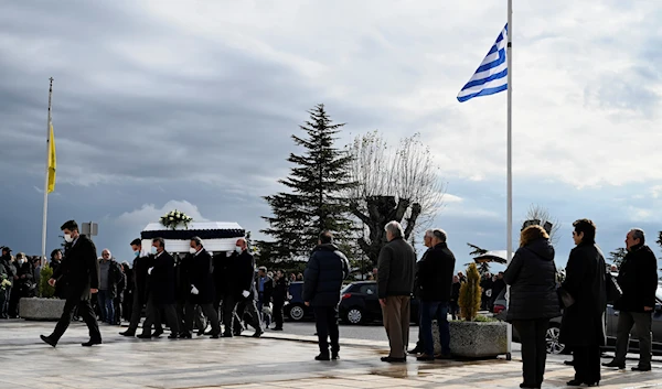 Pallbearers carry the coffin of Sotiris Karageorgiou, one of the victims of a train collision, during a funeral procession, in Thessaloniki, northern Greece, March 4, 2023 (AP Photo)