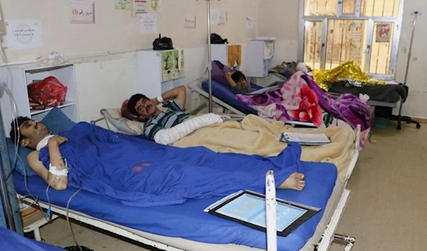 People injured by Saudi-led airstrikes on a detention center lie on hospital beds in Sa’ada, Yemen, on January 22, 2022. (Reuters)