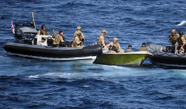 HMS Lancaster' Royal Marines Boarding Team removing missiles from the Iranian boat (AFP).