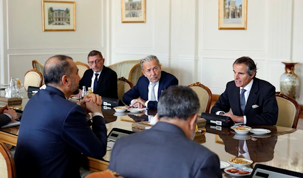 International Atomic Energy Organization Director General Rafael Mariano Grossi, right, speaks with Iranian Foreign Minister Hossein Amirabdollahian, left, during a round of talks, in Tehran, March 4, 2023 (AP Photo)