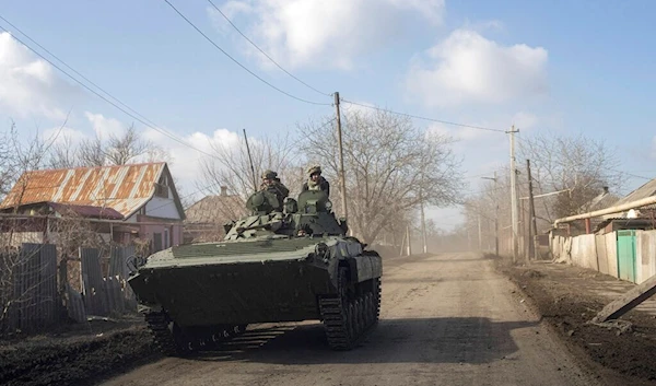 A Ukrainian APC drives towards frontline positions near Bakhmut, Ukraine, Saturday, March 4, 2023 (AP Photo/Evgeniy Maloletka)