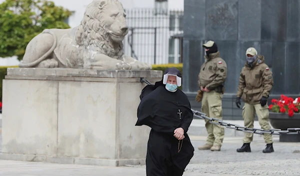 A Roman Catholic nun walks in front of the Presidential Palace in Warsaw, Poland, on Saturday May 16, 2020 (AP Photo/Czarek Sokolowski)