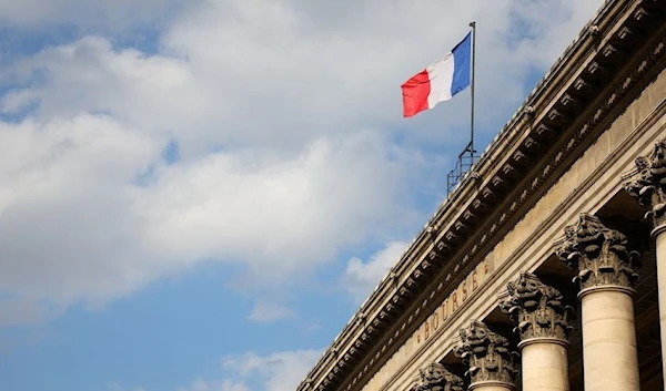 A view shows the French national flag on the top of the Palais Brogniard, former Paris Stock Exchange, located at Place de la Bourse in Paris, France, March 9, 2022. (Reuters)