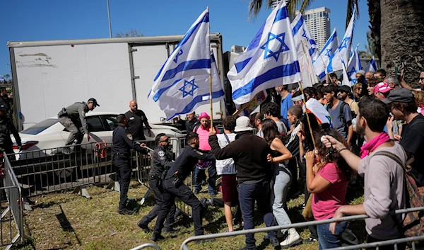 Israeli police scuffle with protesters as they try to block a main road to protest against plans by Prime Minister Benjamin Netanyahu's new government to overhaul the judicial system, in Tel Aviv, Israel, Thursday, March 9, 2023 (AP).