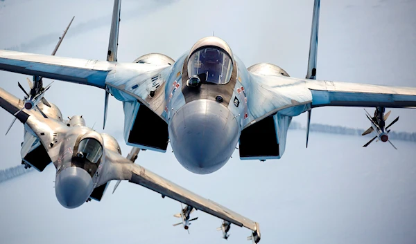 In this photo released by the Russian Defense Ministry Press Service, a pair of Russian Su-35 fighter jets fly in the sky in Russia, Sunday, November 28, 2021 (AP Photo)