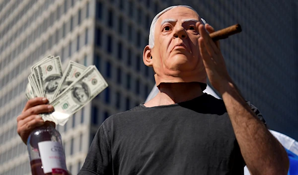 An Israeli demonstrator wears a mask depicting Israeli Prime Minister Benjamin Netanyahu during a protest against plans by his government to overhaul the judicial system, in Tel Aviv, Israel, Thursday, March 9, 2023 (AP).