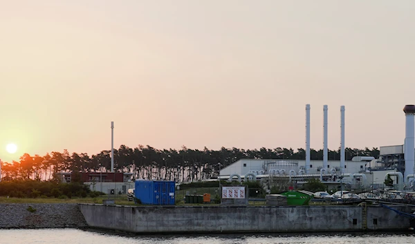 The sun rises behind the landfall facility of the Nord Stream 1 Baltic Sea pipeline and the transfer station of the OPAL gas pipeline, the Baltic Sea Pipeline Link, in Lubmin, Germany, July 21, 2022 (AP Photo)