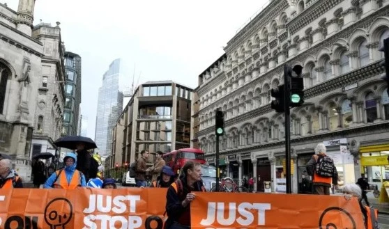 Activists from the group Just Stop Oil block a road in London, Thursday, Oct. 27, 2022 demanding to stop future gas and oil projects from going ahead. (AP)