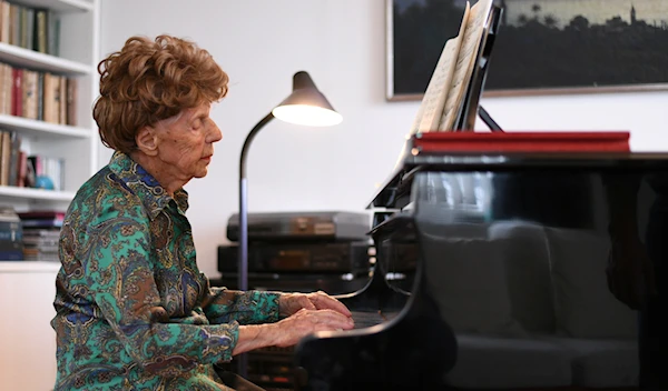 Pianist Collette Maze playing the piano in her home in Paris on February 4, 2021 (Reuters)