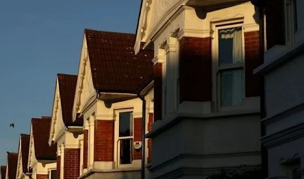 Evening light falls on houses that were built in the early 1900's in London, Britain. (REUTERS)